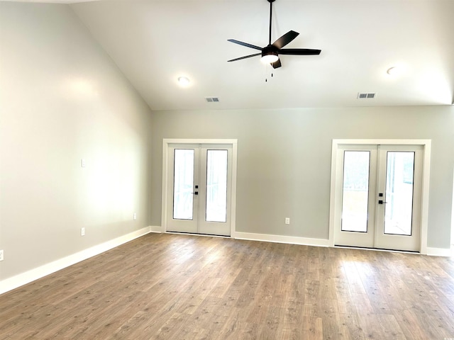 interior space featuring ceiling fan, french doors, wood finished floors, vaulted ceiling, and visible vents