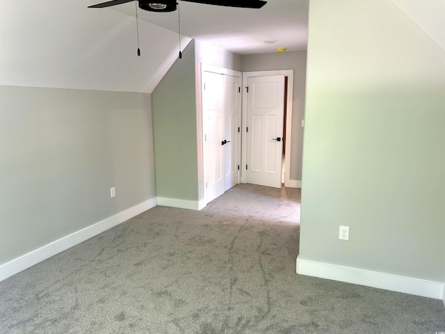 bonus room with carpet floors, a ceiling fan, baseboards, and lofted ceiling