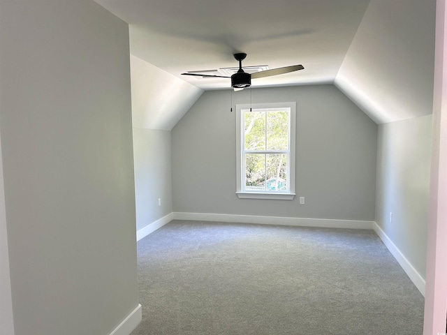 additional living space with baseboards, carpet, ceiling fan, and lofted ceiling