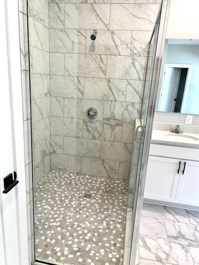 full bath with vanity, a shower stall, and marble finish floor