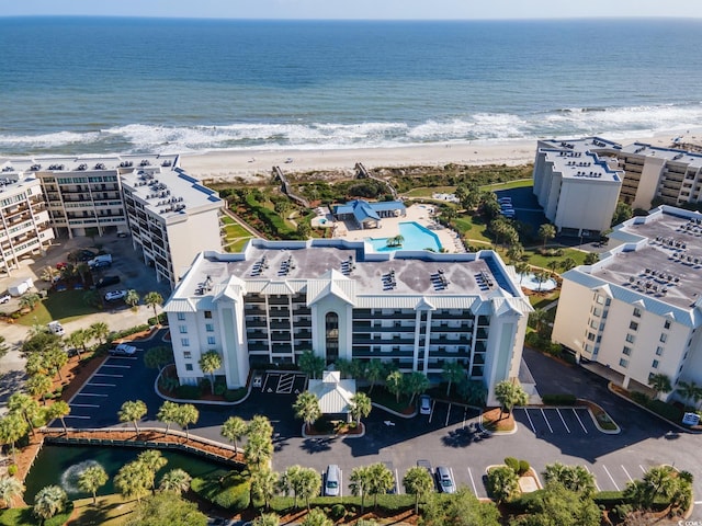 drone / aerial view with a water view and a beach view