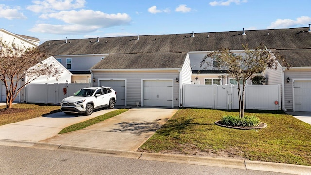 656 Pistoia Ln Unit 304, Myrtle Beach, SC 29579 - view of property with a garage, fence, a front yard, a gate, and concrete driveway