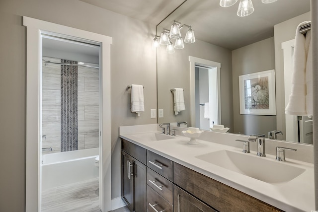 full bathroom featuring a notable chandelier, toilet, shower / tub combo with curtain, vanity, and hardwood / wood-style flooring