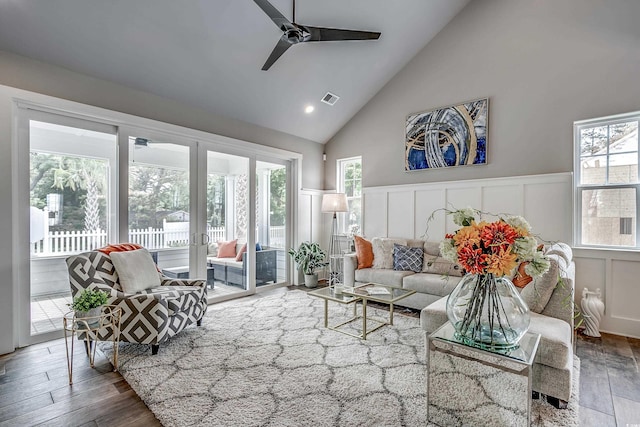 sunroom / solarium with ceiling fan, plenty of natural light, and lofted ceiling