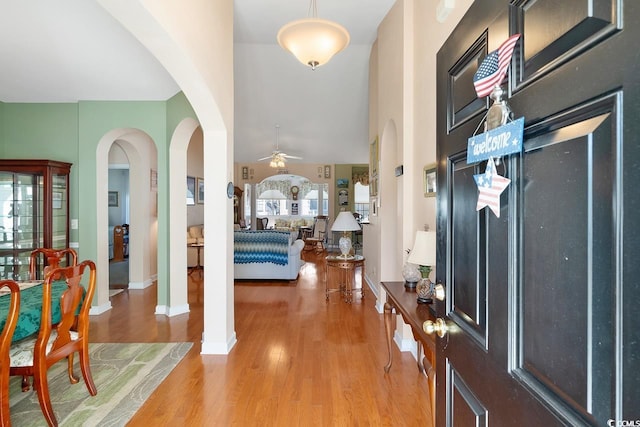 entrance foyer with wood-type flooring, decorative columns, and ceiling fan