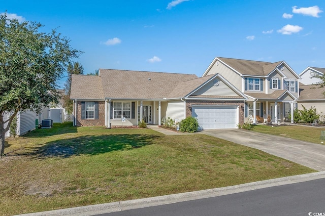 view of front of house with a porch, a garage, central air condition unit, and a front lawn