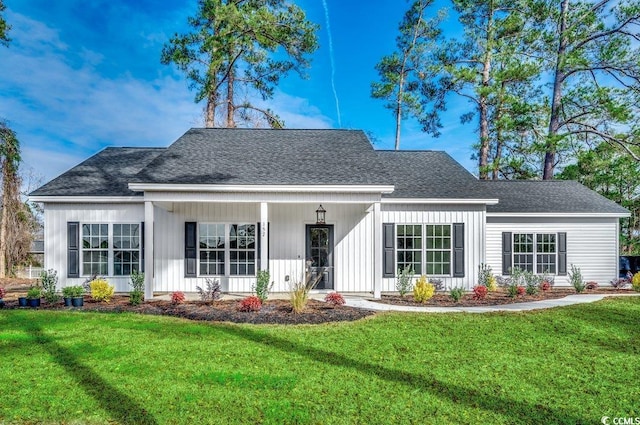 rear view of property with a lawn and covered porch