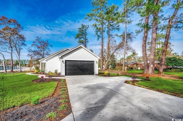 view of side of home with a yard and a garage