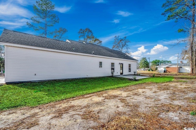 rear view of property featuring a patio area and a yard
