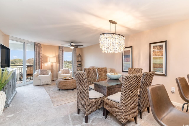 dining room featuring ceiling fan with notable chandelier and light colored carpet