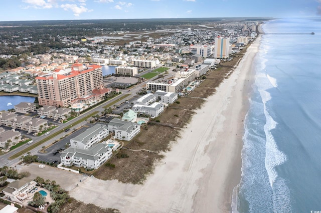 drone / aerial view featuring a water view and a beach view