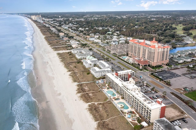 bird's eye view featuring a water view and a beach view