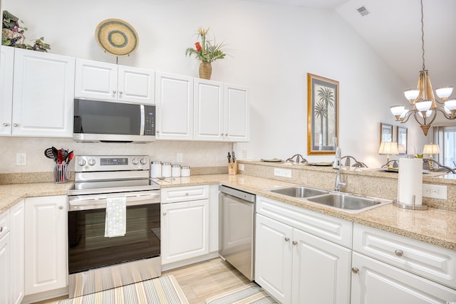 601 Hillside Dr N Unit 4133, North Myrtle Beach, SC 29582 - kitchen featuring stainless steel appliances, a sink, a chandelier, white cabinetry, and decorative light fixtures