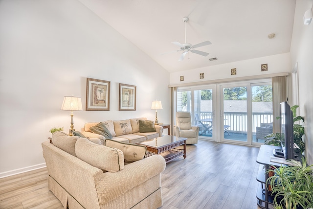 living room with light hardwood / wood-style flooring, high vaulted ceiling, and ceiling fan