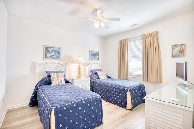 bedroom with ceiling fan and light hardwood / wood-style flooring