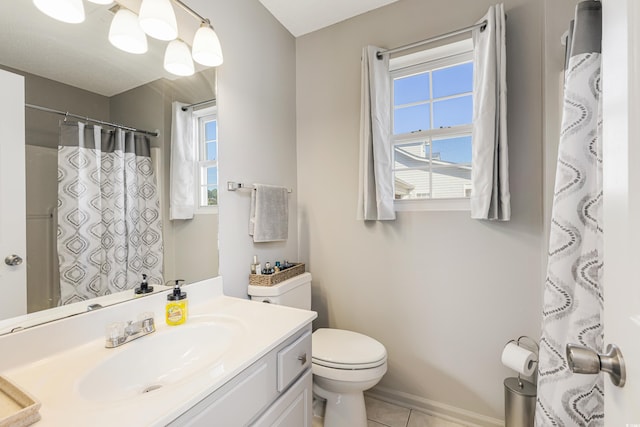 bathroom with tile patterned flooring, vanity, and toilet