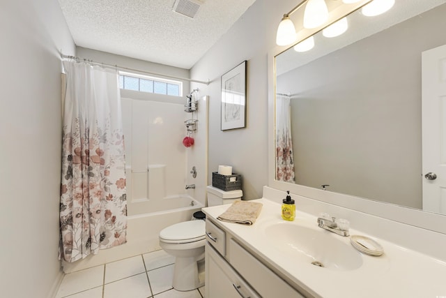 full bathroom featuring vanity, a textured ceiling, shower / tub combo with curtain, tile patterned flooring, and toilet