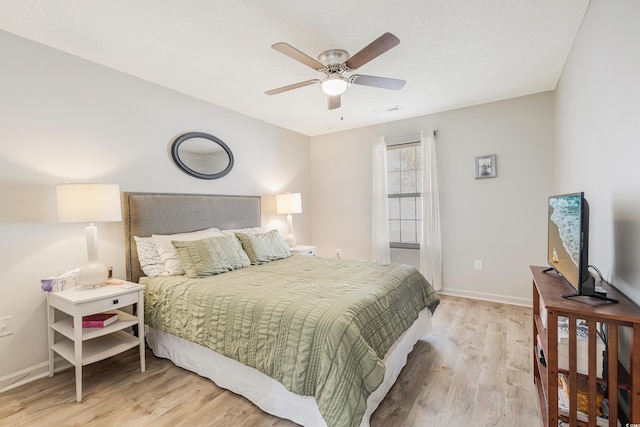 bedroom featuring light hardwood / wood-style flooring and ceiling fan