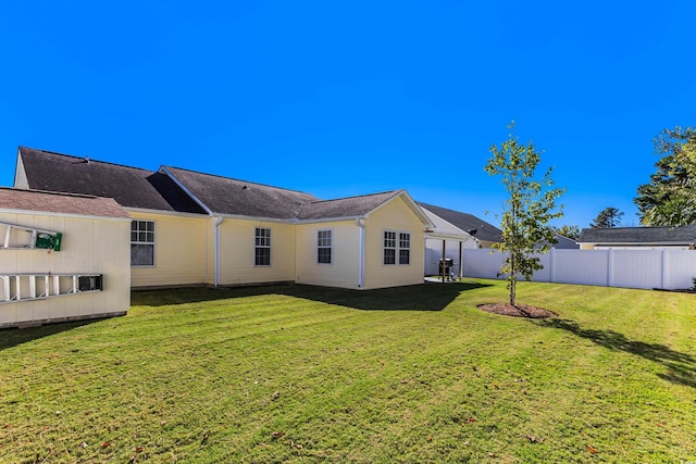 back of house featuring a yard