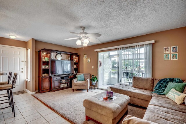 2226 Huntington Dr Unit D, Surfside Beach, SC 29575 - living area featuring a ceiling fan, light tile patterned flooring, a textured ceiling, light colored carpet, and baseboards