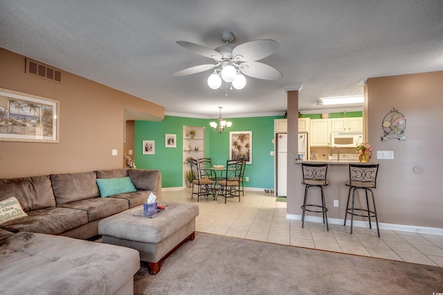 2226 Huntington Dr Unit D, Surfside Beach, SC 29575 - living room featuring light tile patterned floors, a ceiling fan, a chandelier, light colored carpet, and a textured ceiling