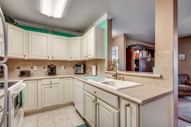 2226 Huntington Dr Unit D, Surfside Beach, SC 29575 - kitchen featuring a sink, white appliances, a textured ceiling, backsplash, and light countertops