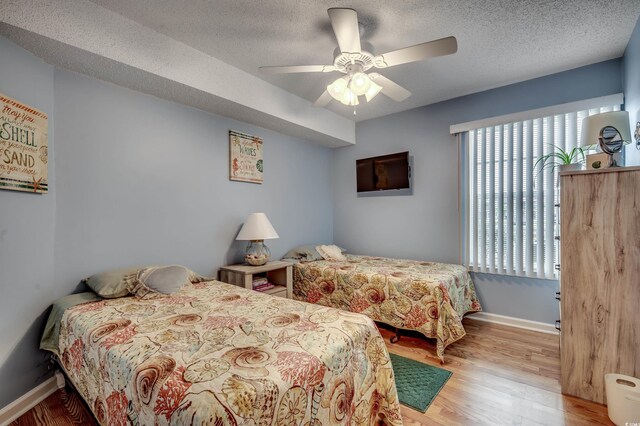 2226 Huntington Dr Unit D, Surfside Beach, SC 29575 - bedroom featuring wood finished floors, baseboards, a textured ceiling, and ceiling fan