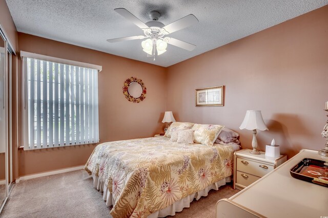 2226 Huntington Dr Unit D, Surfside Beach, SC 29575 - bedroom with carpet, a closet, baseboards, a textured ceiling, and ceiling fan