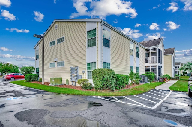 2226 Huntington Dr Unit D, Surfside Beach, SC 29575 - view of building exterior featuring central AC and uncovered parking