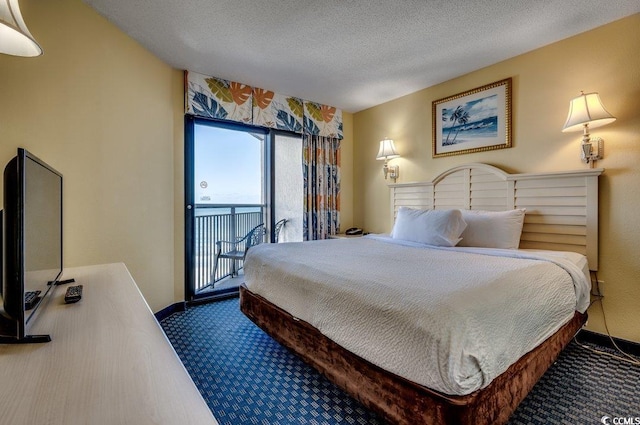 bedroom featuring carpet, a textured ceiling, and access to outside