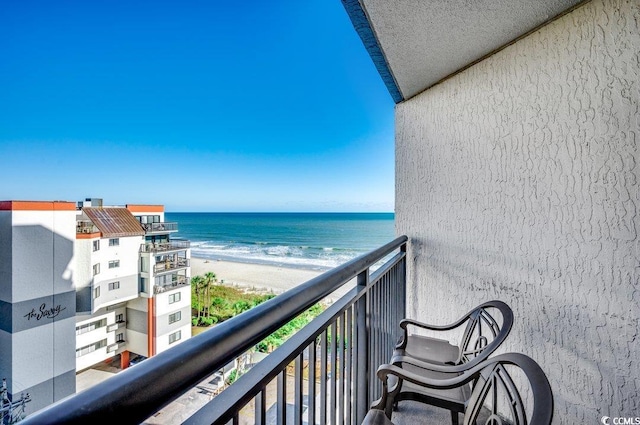 balcony featuring a water view and a view of the beach