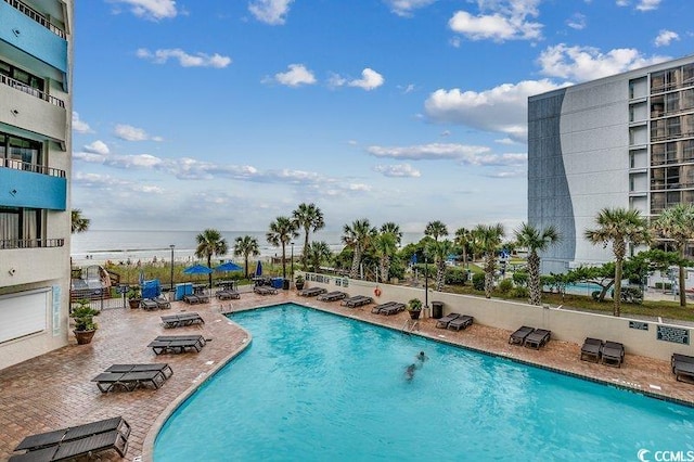 view of swimming pool with a patio