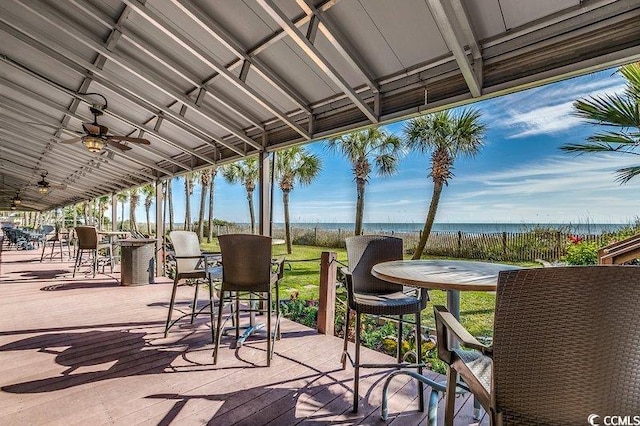 view of patio featuring a water view and ceiling fan