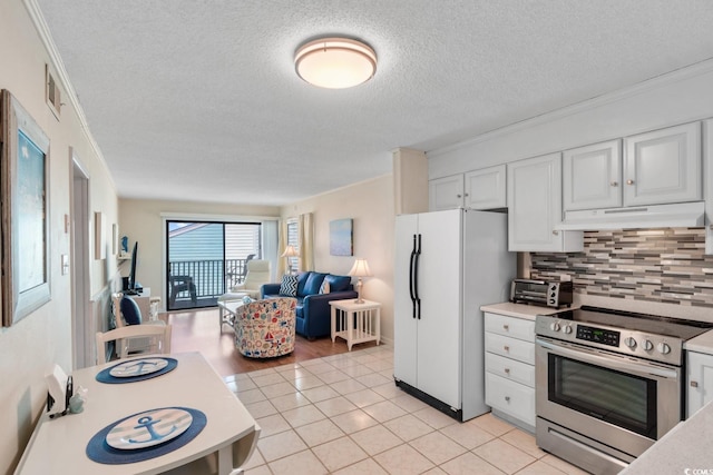 kitchen with ornamental molding, electric stove, white fridge, white cabinetry, and light tile patterned flooring