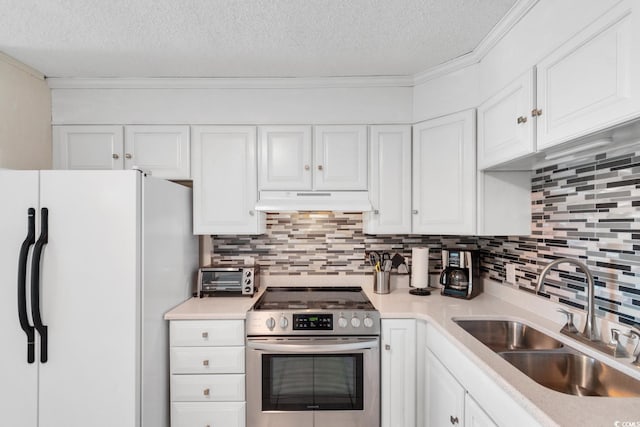 kitchen featuring backsplash, stainless steel electric stove, sink, white fridge, and white cabinetry