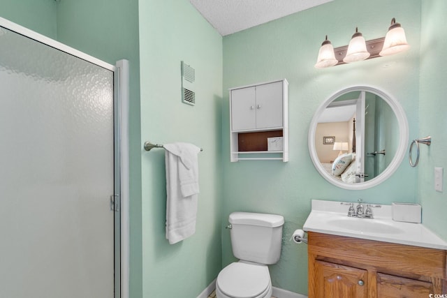 bathroom featuring vanity, toilet, a textured ceiling, and walk in shower