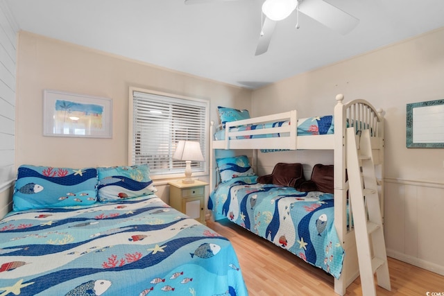 bedroom with light hardwood / wood-style floors and ceiling fan