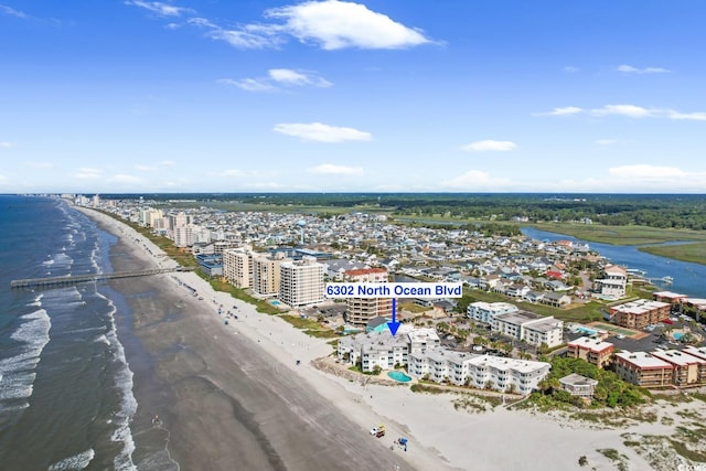 drone / aerial view with a water view and a beach view