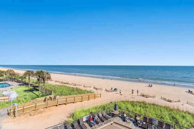 property view of water featuring a beach view and fence