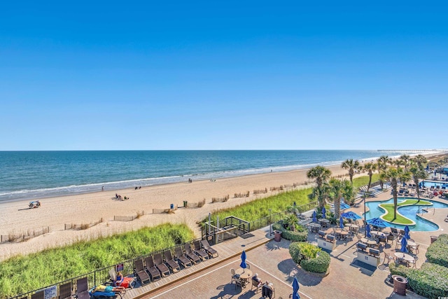 view of water feature with fence and a view of the beach