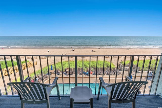 balcony featuring a beach view and a water view