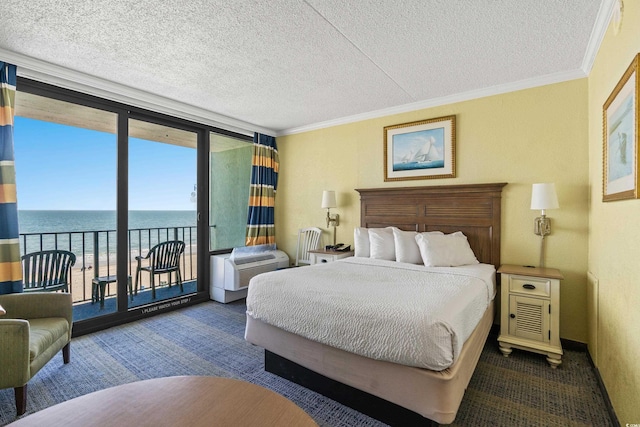 carpeted bedroom featuring a textured ceiling, a water view, access to exterior, ornamental molding, and a wall of windows