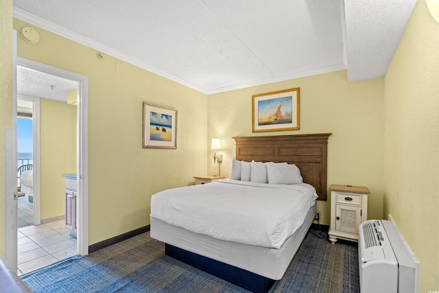 bedroom featuring a textured ceiling, ornamental molding, and baseboards