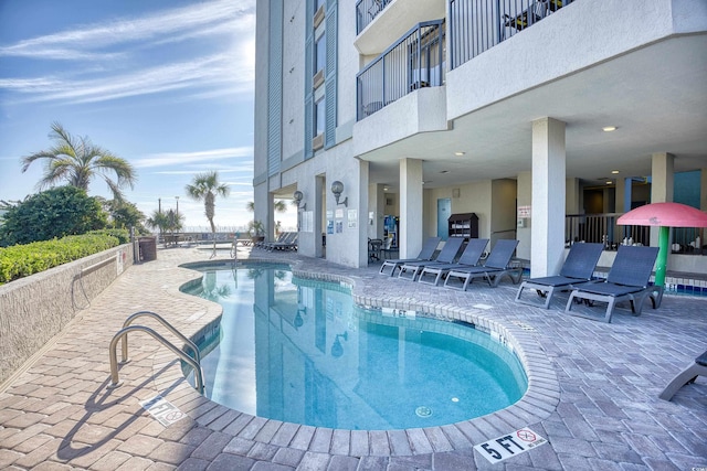 view of swimming pool with a patio area