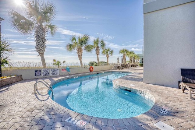 view of swimming pool featuring a patio area