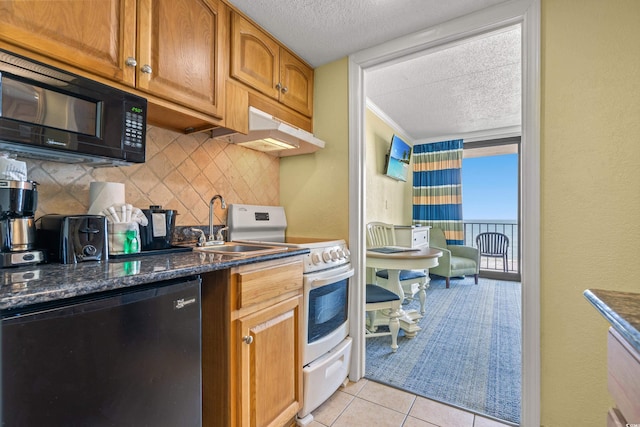 kitchen featuring black microwave, electric range, dishwashing machine, and a textured ceiling