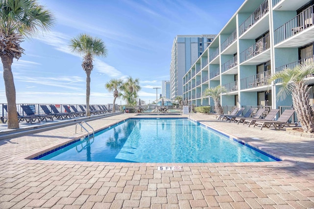 view of swimming pool featuring a patio area