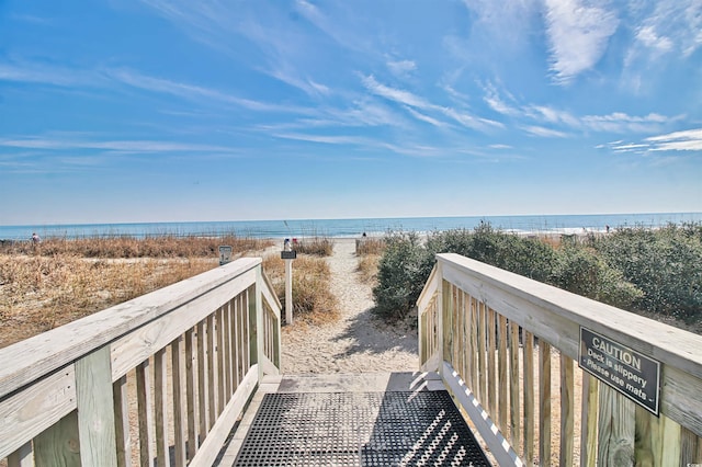 view of home's community featuring a water view and a view of the beach