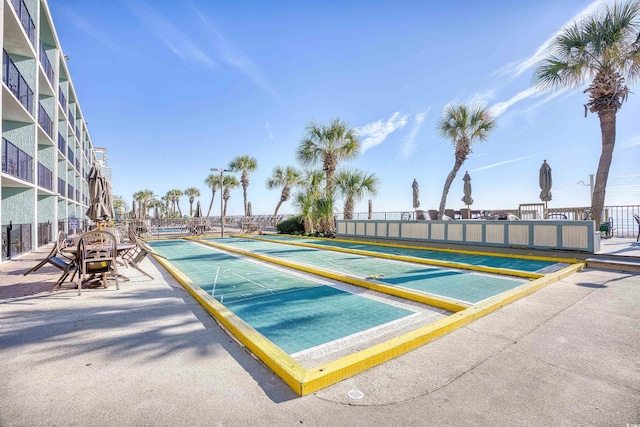 surrounding community featuring fence and shuffleboard