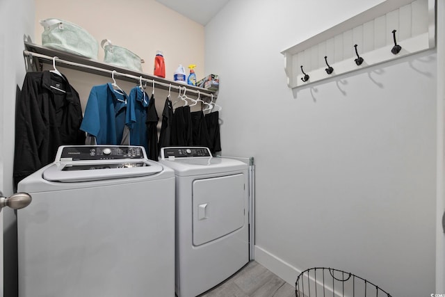 laundry area featuring washer and clothes dryer and light wood-type flooring